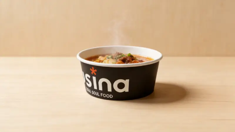 paper bowl holding hot noodles with steam