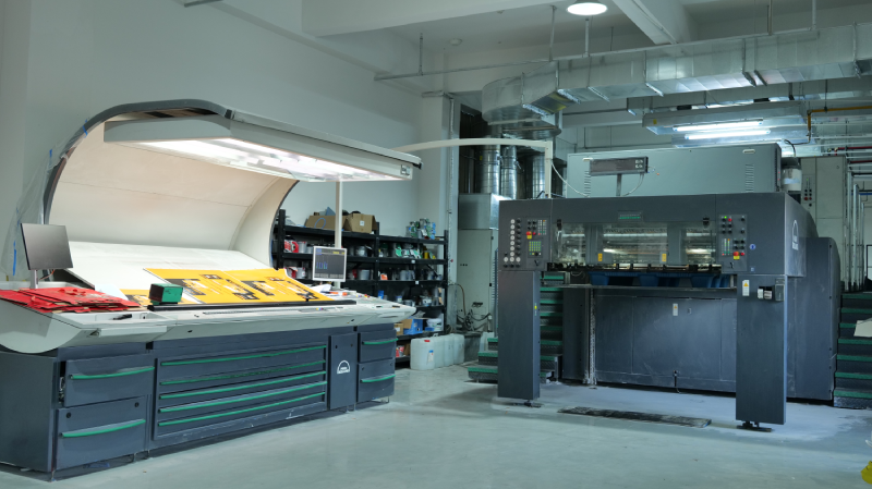 Modern offset printing machine producing printed paper sheets for food packaging