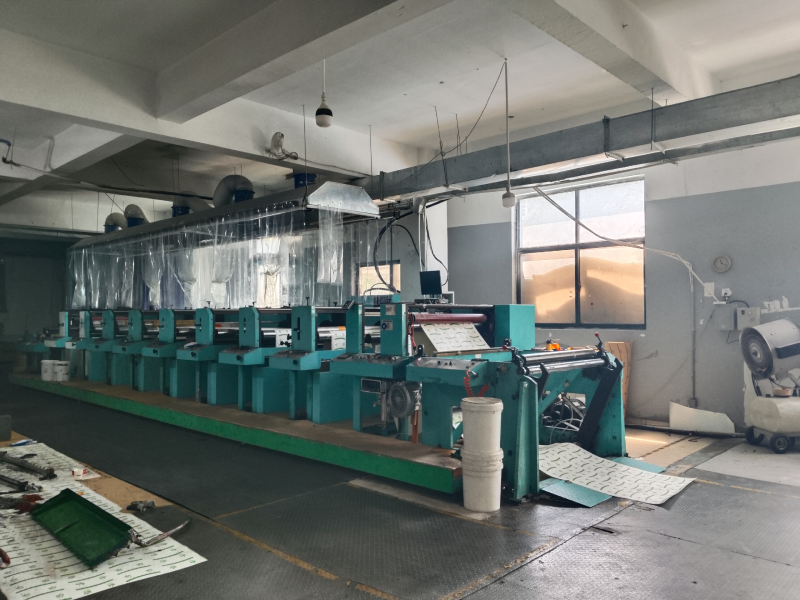 Flexographic printing press producing custom printed paper cups.